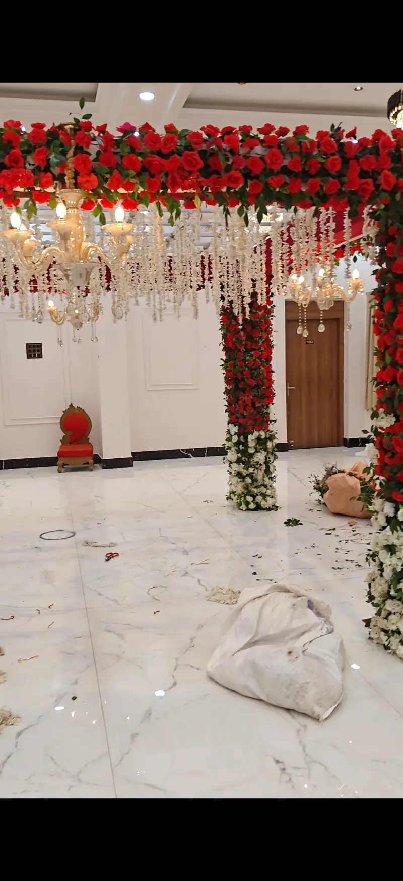 Red rose mandap close-up with fairy lights