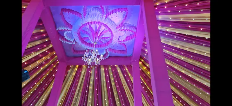Tent ceiling decoration with purple lighting and chandelier