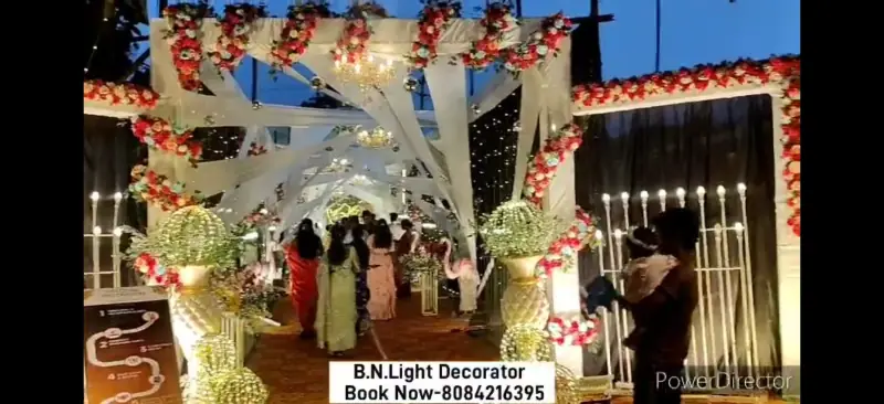 Wedding entrance with flower arch and guests