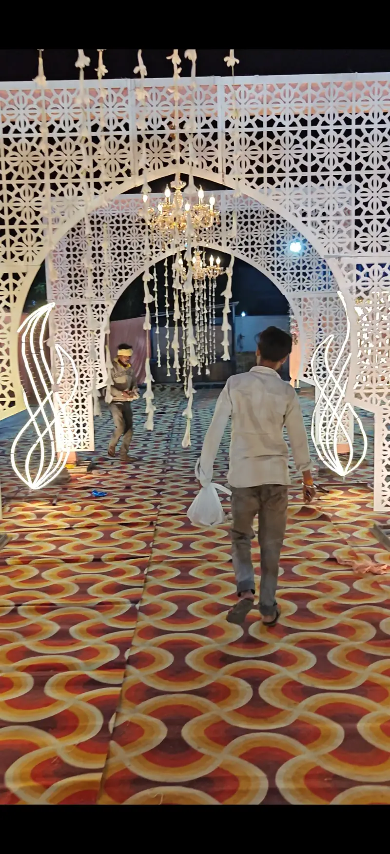 Elegant white arch entrance with fairy light drapes
